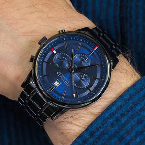 Tommy Hilfiger Kyle 1791633 herrklocka med svart stålarmband och blå urtavla, visad framifrån.